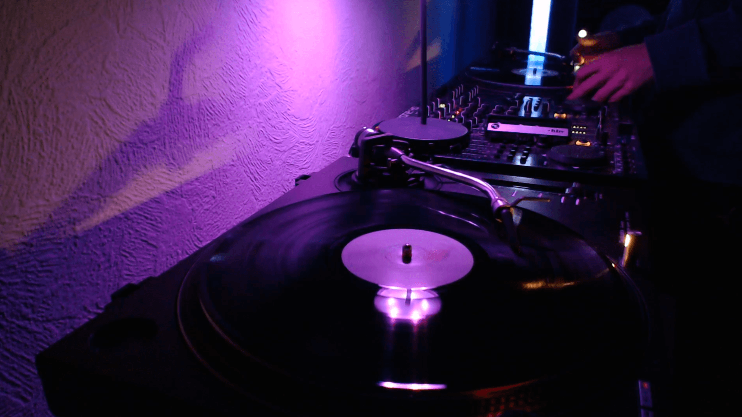 Turntable spinning under purple light
